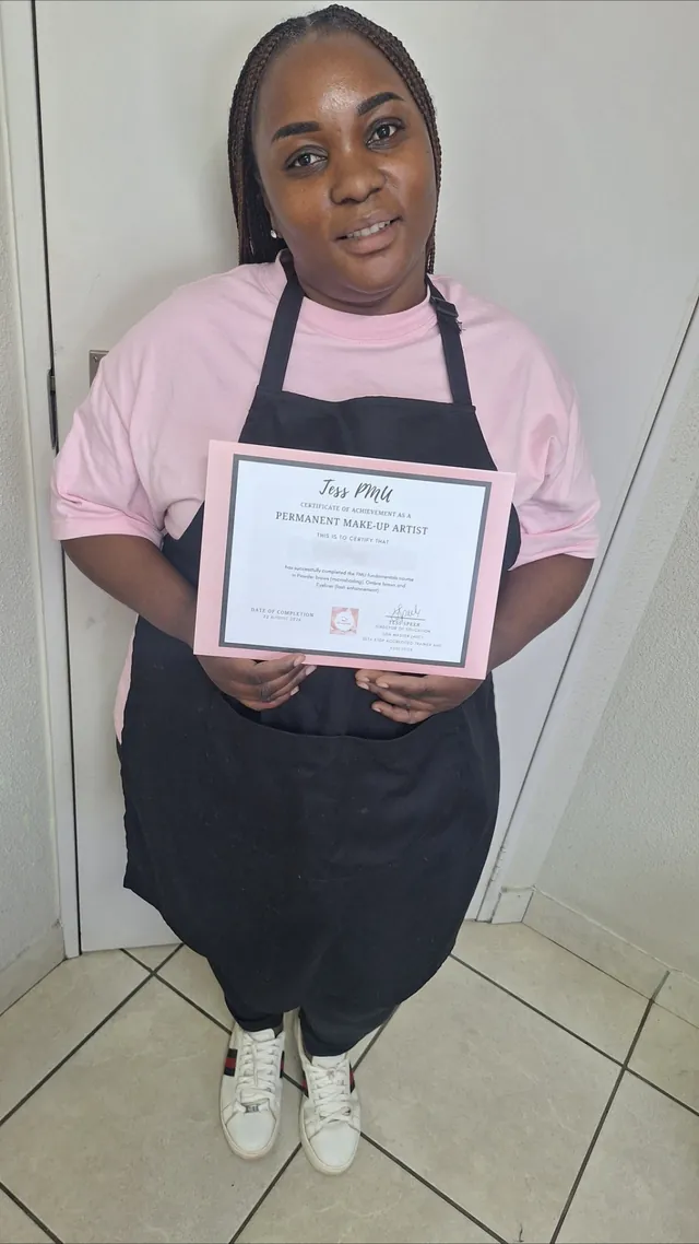 PMU student with her certificate after completing her course